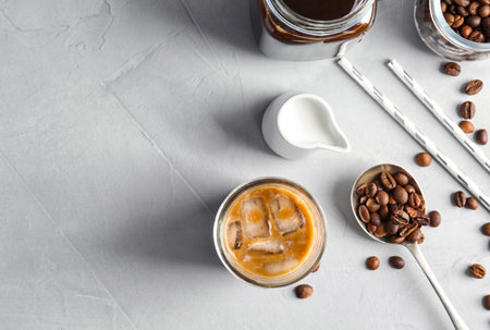 Flat lay composition with cold brew coffee and milk on gray background