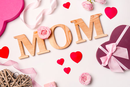 Beautiful composition with word "MOM" on white background. Happy Mother's Dayの写真素材