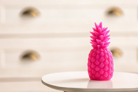 Stylish pineapple candle on table. home decorating ideasの写真素材