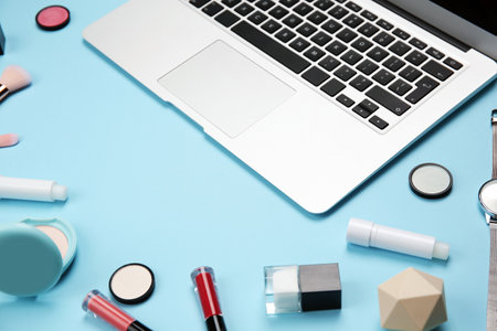 Composition with laptop and makeup products for woman on color backgroundの写真素材