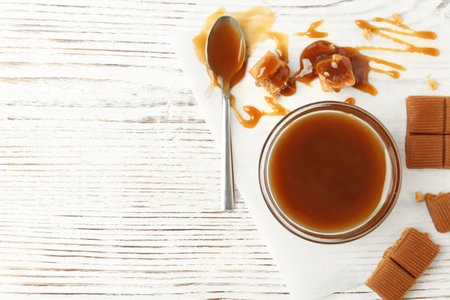 Delicious candies with caramel sauce on table, top viewの写真素材