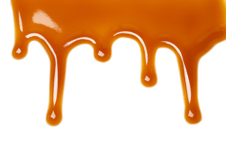 Delicious caramel sauce on white backgroundの写真素材