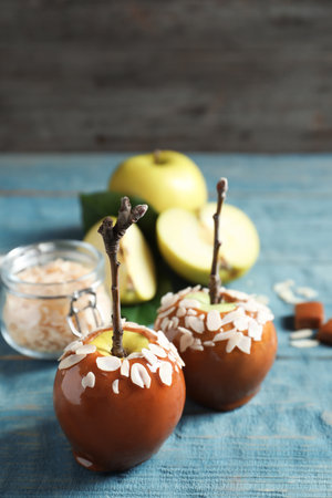 Delicious caramel apples on wooden backgroundの写真素材