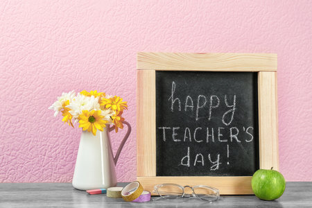 Composition with small chalkboard for Teacher's day on tableの写真素材