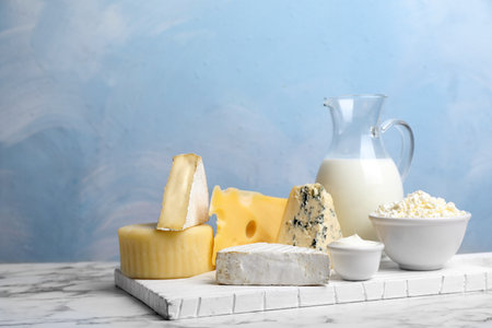 Fresh dairy products on table against color backgroundの写真素材