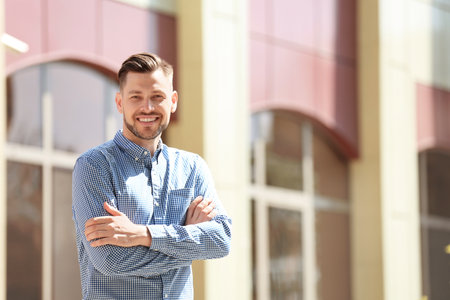 Portrait of young man in stylish outfit outdoorsの写真素材