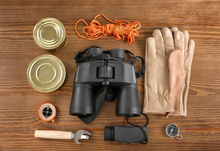 Flat lay composition with camping equipment on wooden backgroundの写真素材