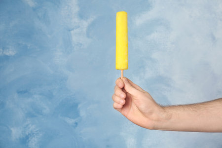 Man holding yummy ice cream on color background. focus on handの写真素材