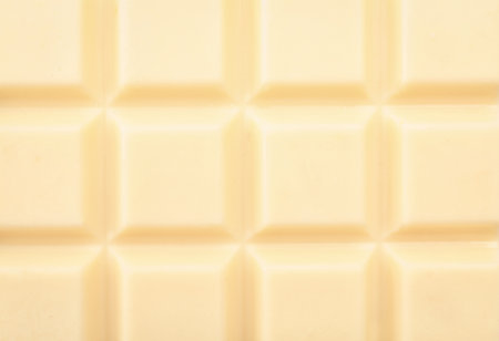 Delicious white chocolate bar as backgroundの写真素材
