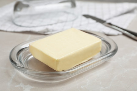 Plate with tasty fresh butter on tableの写真素材