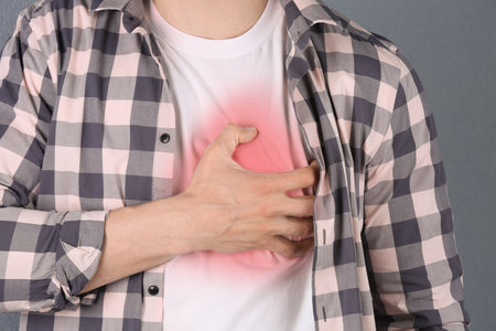 Young man having heart attack, closeupの写真素材