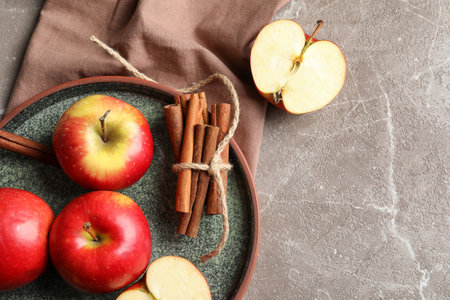 Fresh apples and cinnamon sticks on table, top viewの写真素材