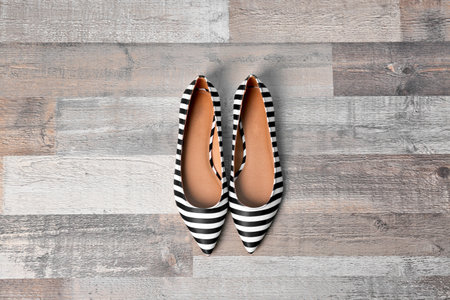 Pair of female shoes on wooden background, top viewの写真素材