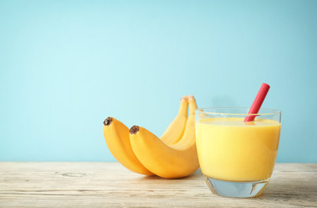 Glass with delicious detox smoothie on tableの写真素材
