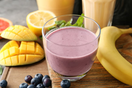 Glass with healthy detox smoothie and ingredients on tableの写真素材
