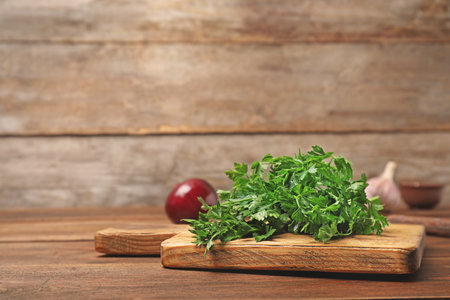 Board with fresh green parsley on tableの写真素材