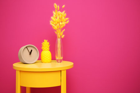 Stylish pineapple candle on table against color background. home decorating ideasの写真素材