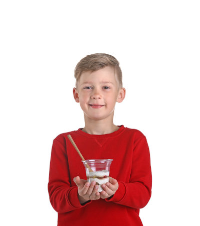 Little boy with yogurt on white backgroundの写真素材