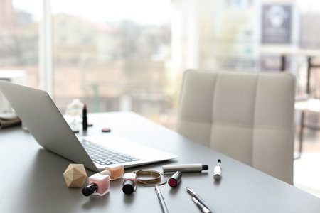 Makeup products for woman and laptop on tableの写真素材