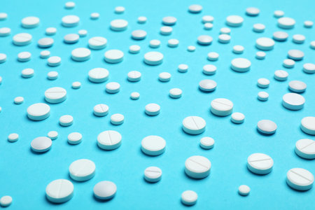 White pills on color background