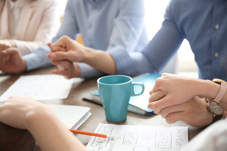 People holding hands together at table. unity conceptの写真素材