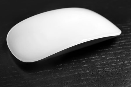 Wireless computer mouse on black background