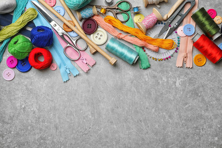 Composition with threads and sewing accessories on gray backgroundの写真素材
