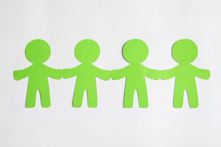 Paper people holding hands on light background. unity conceptの写真素材