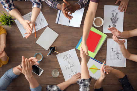 Man and woman shaking hands at table, top view. unity conceptの写真素材