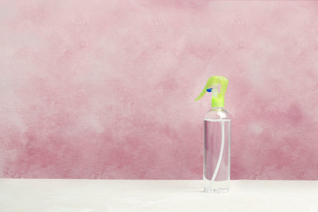 Spray air freshener on table against color backgroundの写真素材