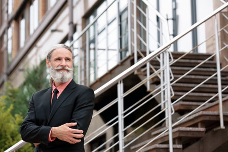 Handsome bearded mature man in suit, outdoorsの写真素材