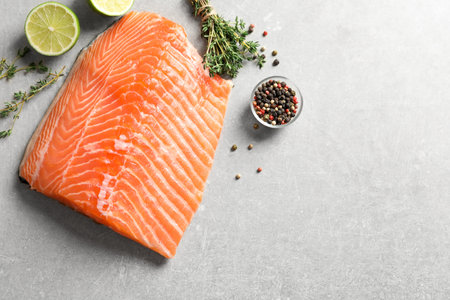 Raw salmon fillet and ingredients for marinade on table, top viewの写真素材