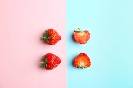 Flat lay composition with tasty ripe strawberries on color backgroundの写真素材