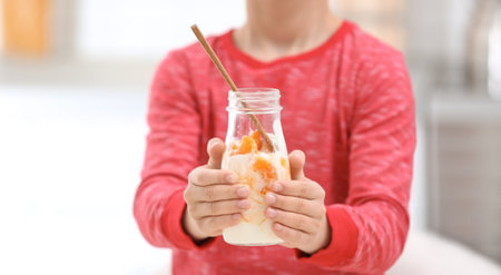 Little boy with yogurt in kitchen, closeupの写真素材