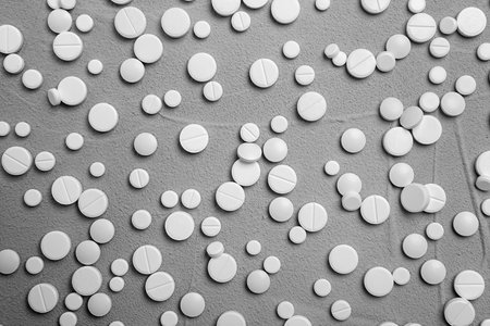 White pills on gray background, flat layの写真素材