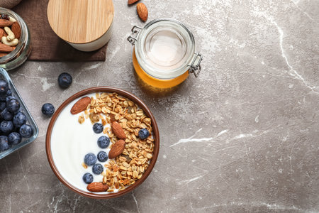 Tasty breakfast with yogurt, berries and granola on table, top viewの写真素材