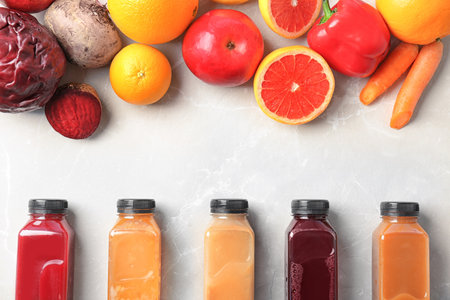 Flat lay composition with healthy detox smoothies and ingredients on light backgroundの写真素材