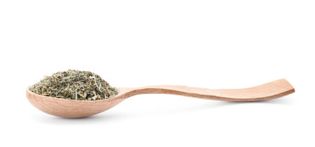 Wooden spoon with dried parsley on white backgroundの写真素材