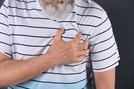 Mature man having heart attack, closeup