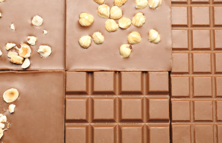 Different delicious milk chocolate bars as background