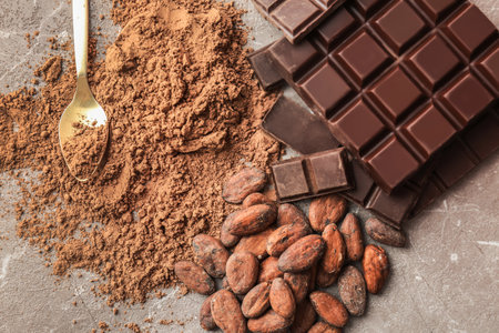 Delicious chocolate, cocoa powder and beans on table, top viewの写真素材