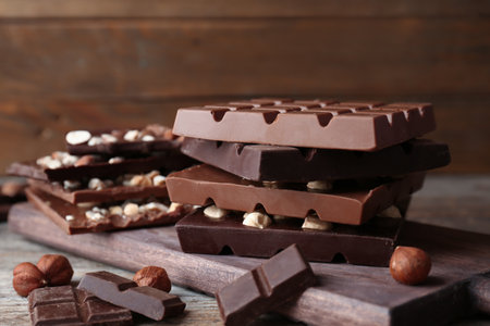 Different delicious milk and dark chocolate bars on tableの写真素材