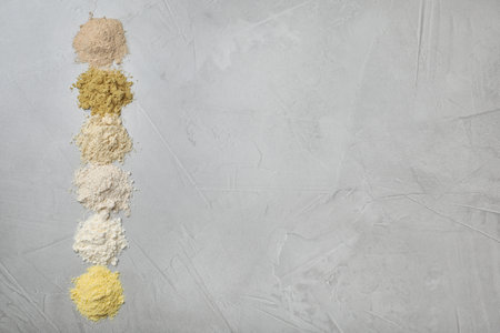 Composition with different types of flour on light backgroundの写真素材