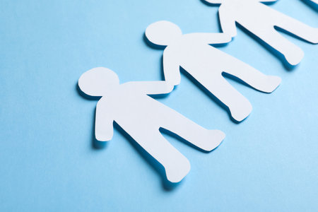 Paper people holding hands on color background. unity conceptの写真素材