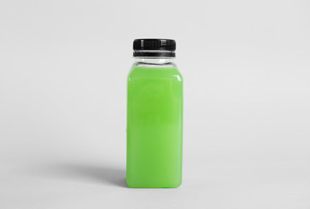 Bottle with delicious fresh juice on light backgroundの写真素材