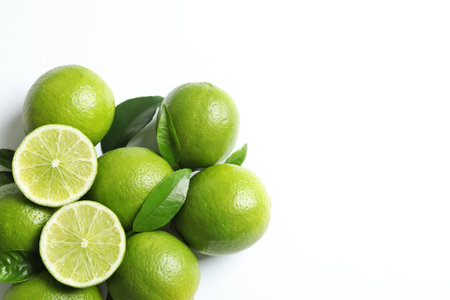 Fresh ripe limes on white background, top view