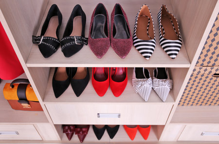 Wardrobe shelves with different stylish shoesの写真素材