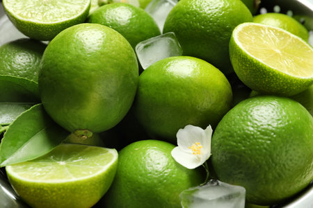 Fresh ripe limes and ice cubes, closeupの写真素材