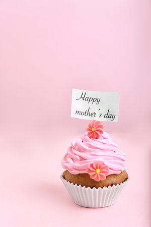 Topper with words HAPPY MOTHER'S DAY in cupcake on color backgroundの写真素材