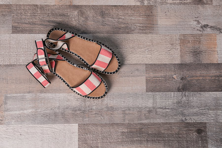 Pair of female shoes on wooden background, top viewの写真素材